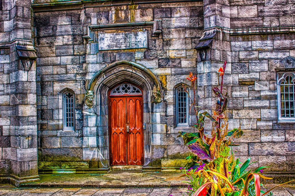 Old grey stone building in Dublin with red door 